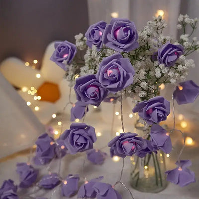 Purple rose fairy lights in a vase, surrounded by twinkling lights, perfect for home and garden decor.